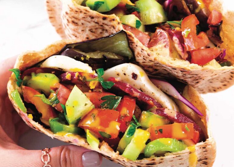 Sabich, an Israeli pita sandwich stuffed with sautéd eggplants, hard boiled eggs, and more